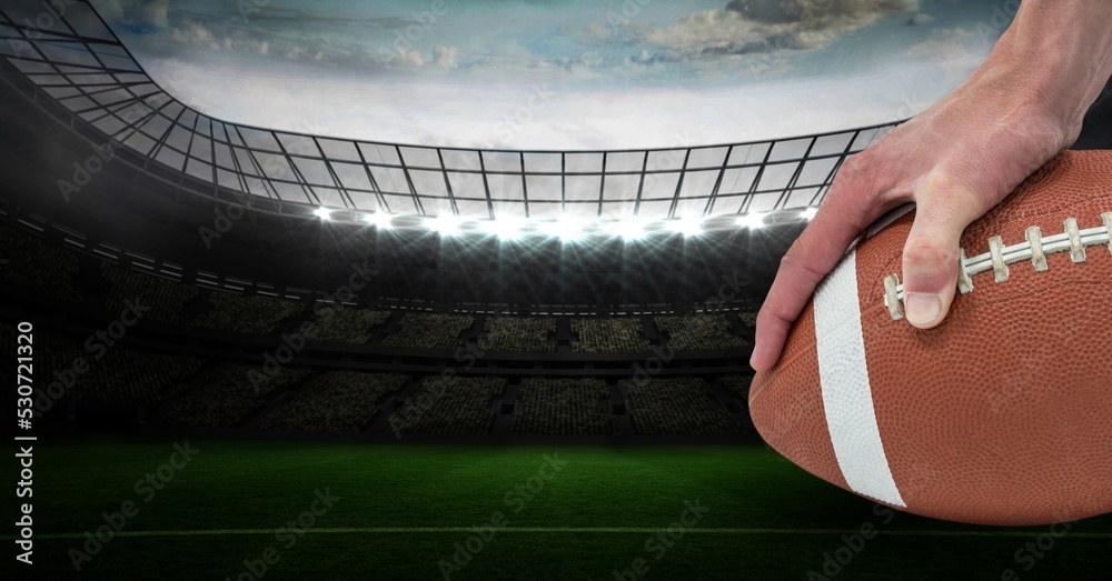 Composition of male rugby player holding rugby ball over sports stadium