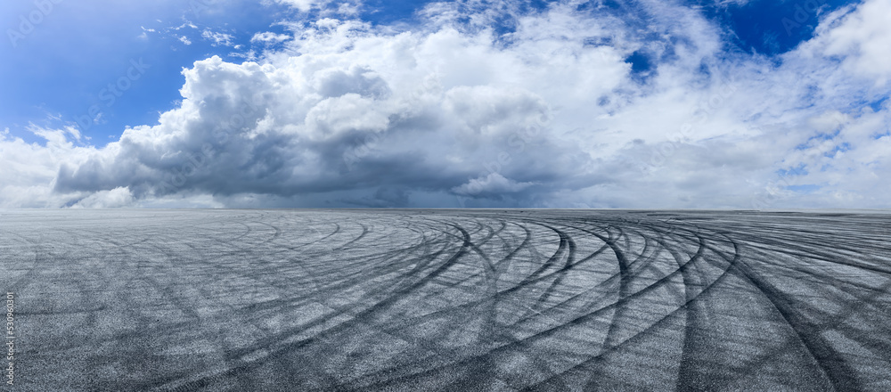 Empty asphalt race track road with sky clouds background. panoramic view.