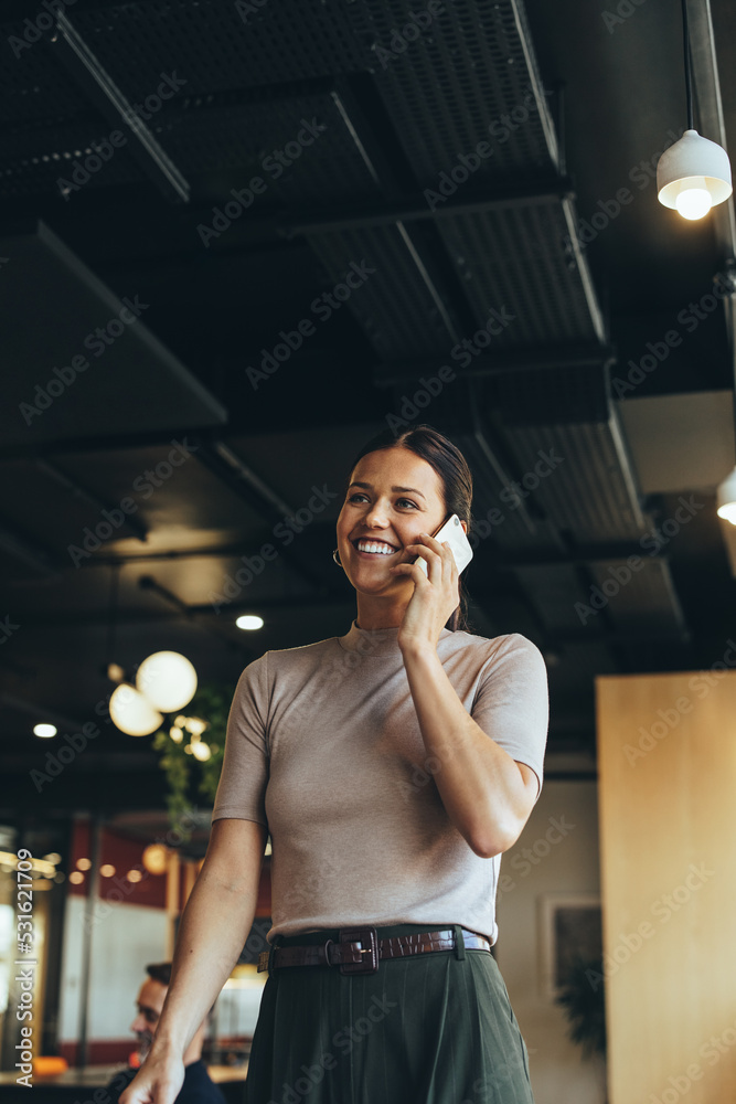 Businesswoman taking a phone call in a co-working space