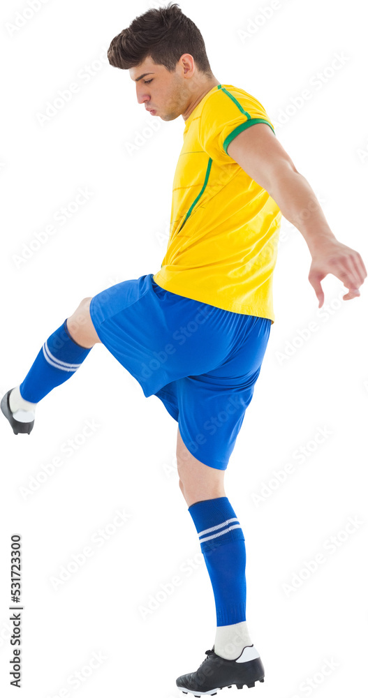 Image of caucasian male soccer player in yellow and blue team strip kicking