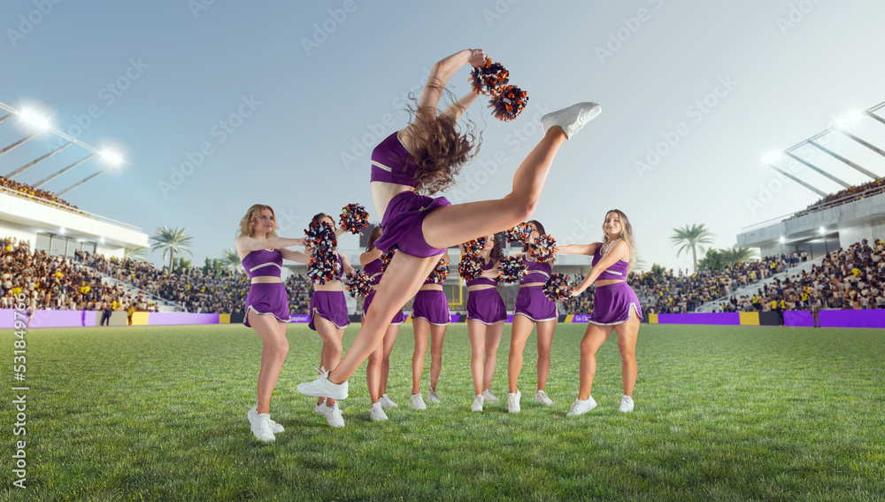 Group of cheerleaders in action on  stadium