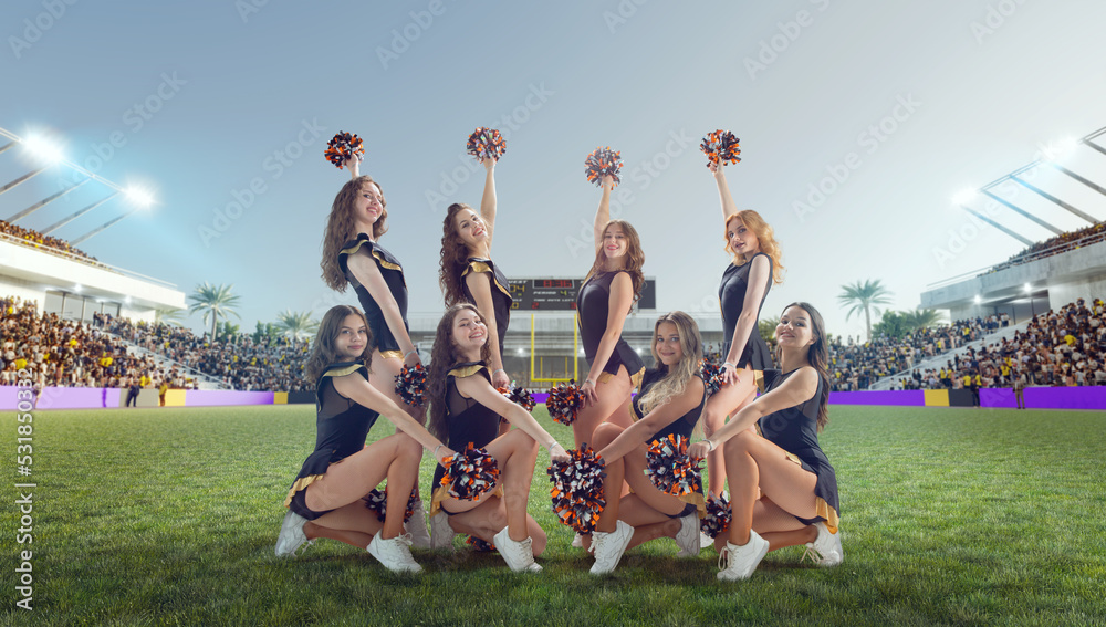 Group of cheerleaders in action on  stadium