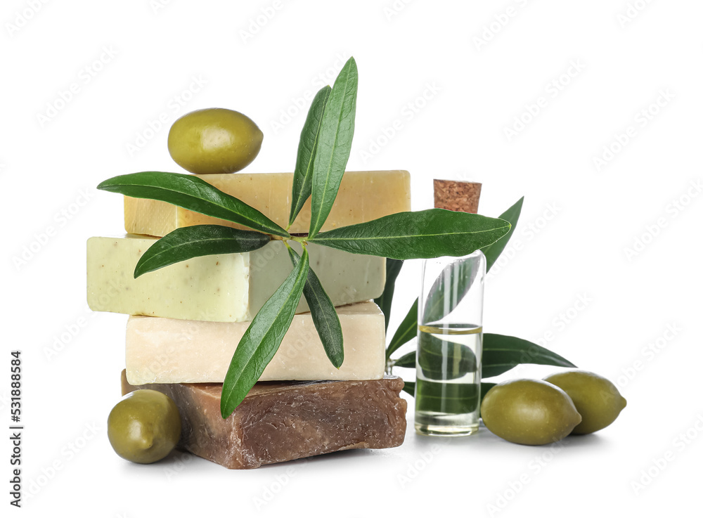 Stack of olive soap bars and essential oil on white background