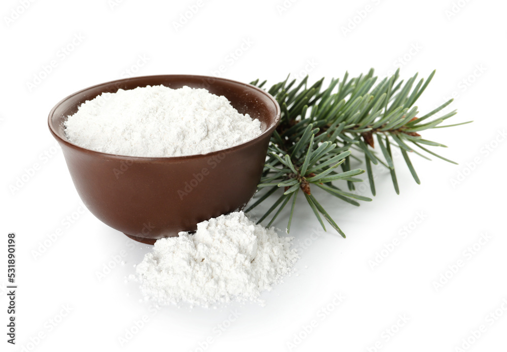 Bowl of tooth powder with coniferous branches on white background