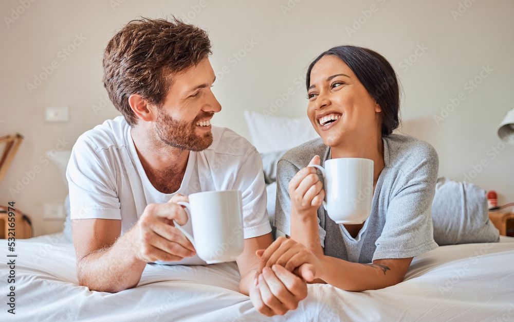 Couple coffee, interracial smile and relax on bed in house, smile for love marriage and funny commun