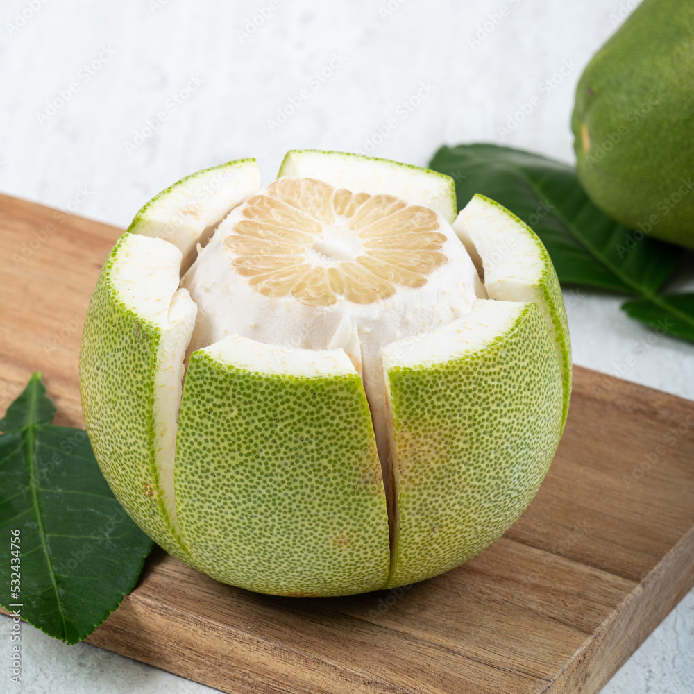 Fresh pomelo fruit on white table background.