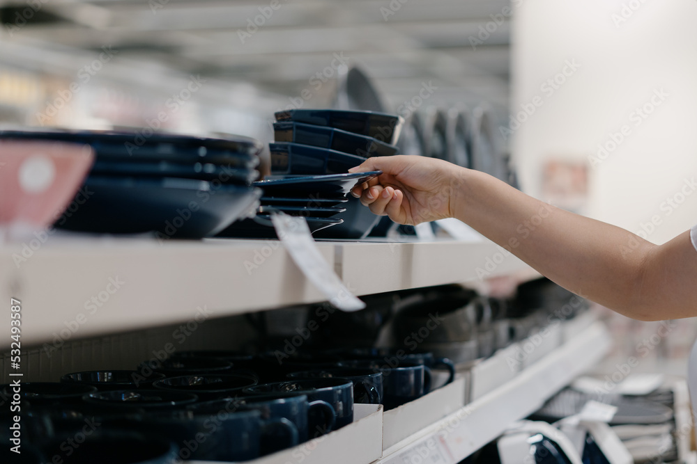 woman buying cutlery in mall