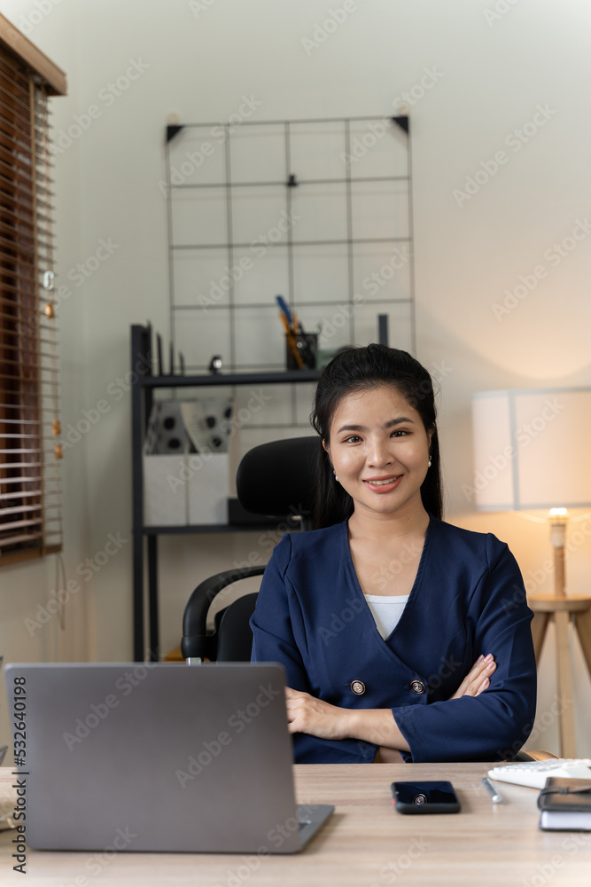 Asian woman working with laptop in her office. business financial concept.