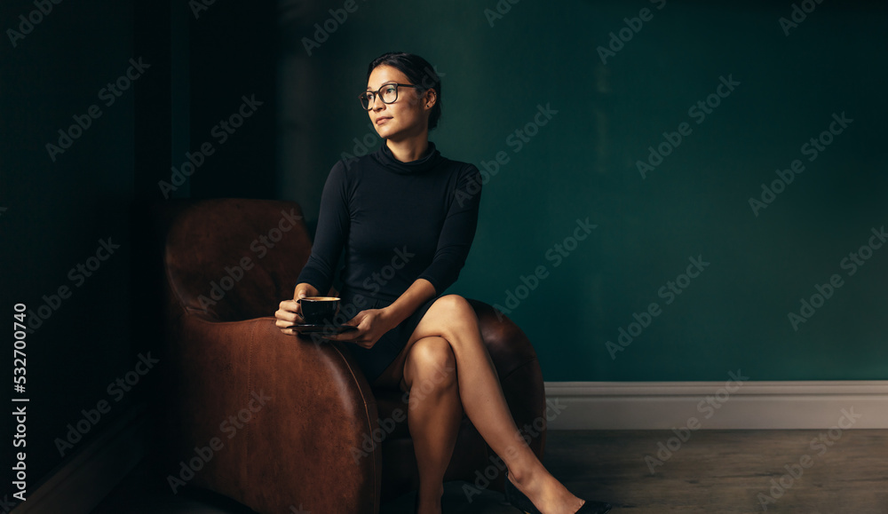 Thoughtful businesswoman relaxing in her office