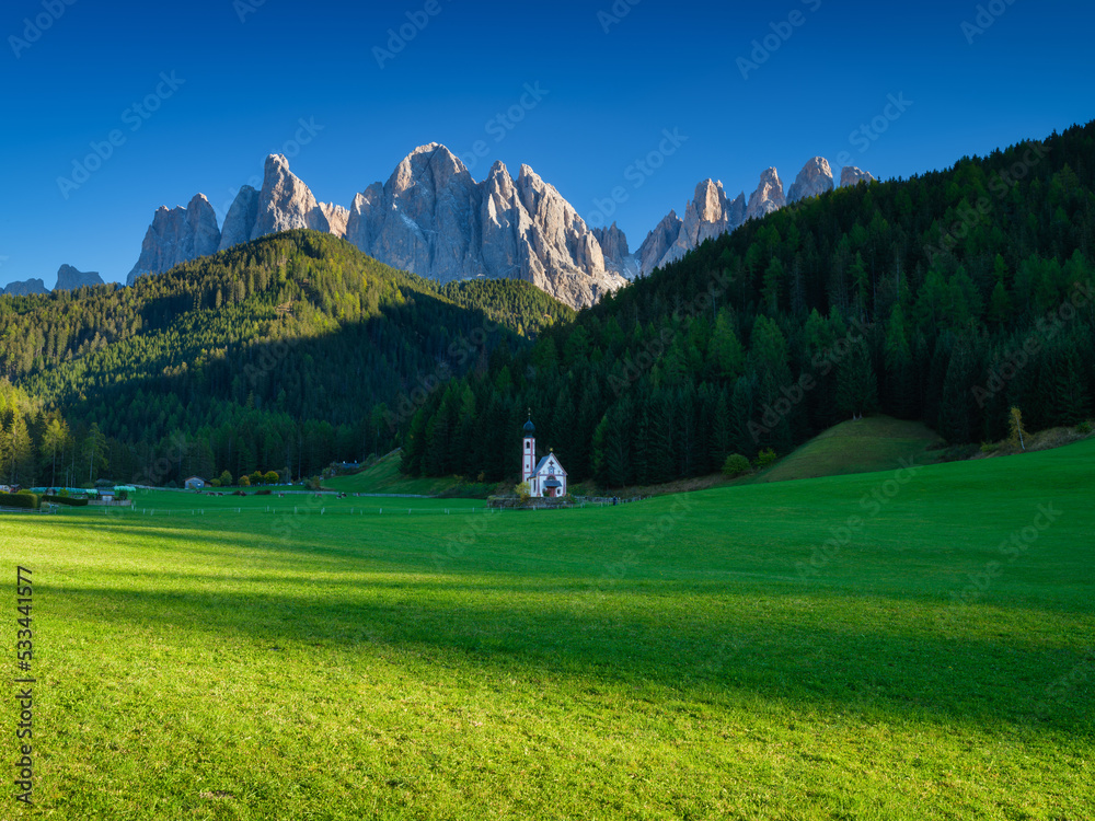 Santa Maddalena. Val di Funes. Dolomite Alps. Italy. Church in the meadow. The mountains and the for