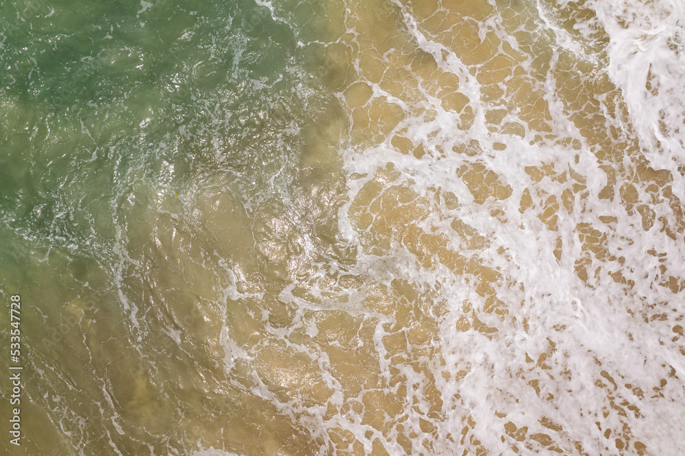 Aerial view drone over beach sea, Beautiful sea waves background, Beach sand sea surface, Summer sea