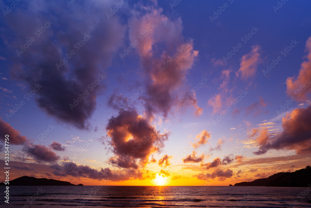 Landscape Long exposure of majestic clouds in the sky sunset or sunrise over sea with reflection in 