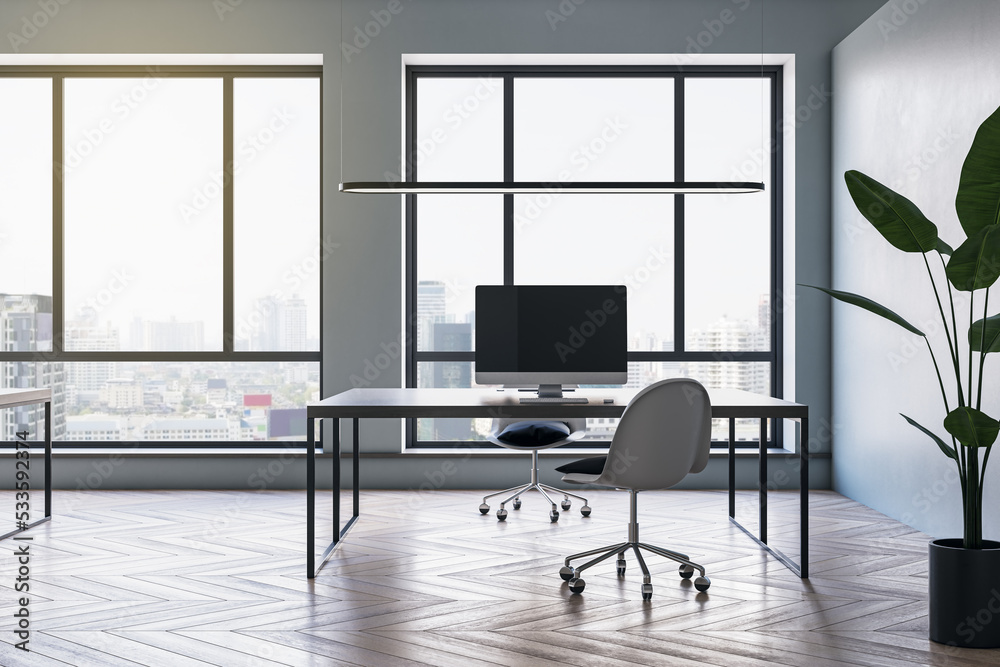 Clean meeting room office interior with wooden flooring, furniture, computers, window with city view