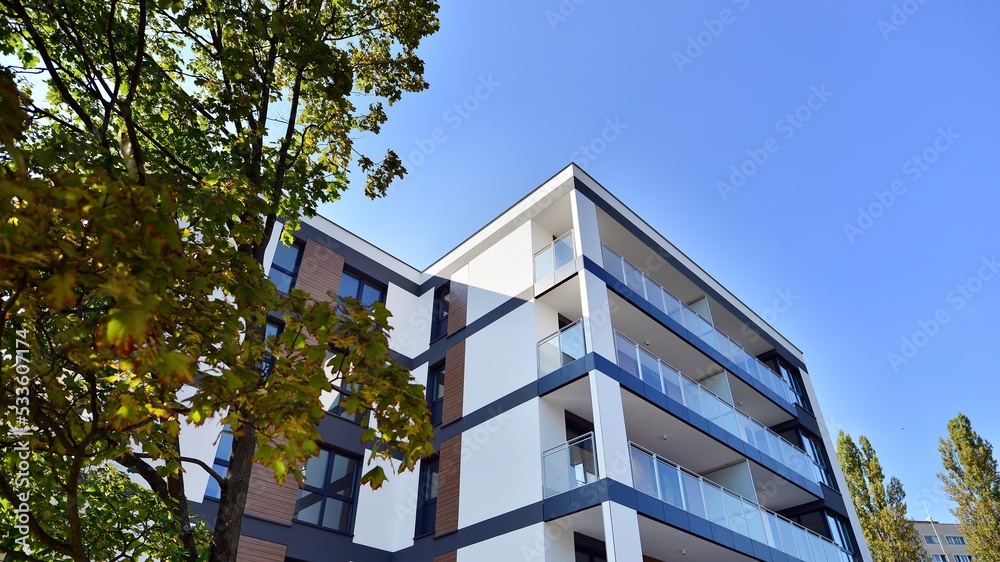 Modern residential building with new apartments in a green residential area. Eco architecture. Green