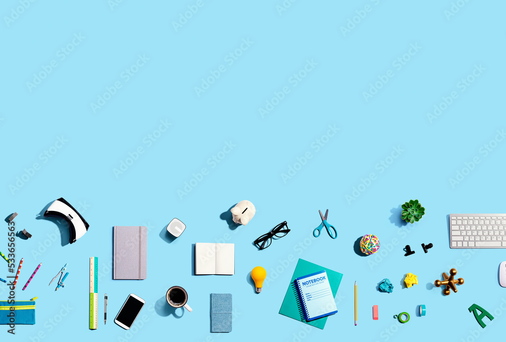 Collection of electronic gadgets and office supplies - flat lay