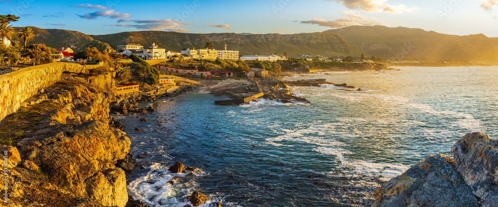 Early morning coastal view from Gearing’s Point of the rocky Hermanus coastline and Old Harbour, wit