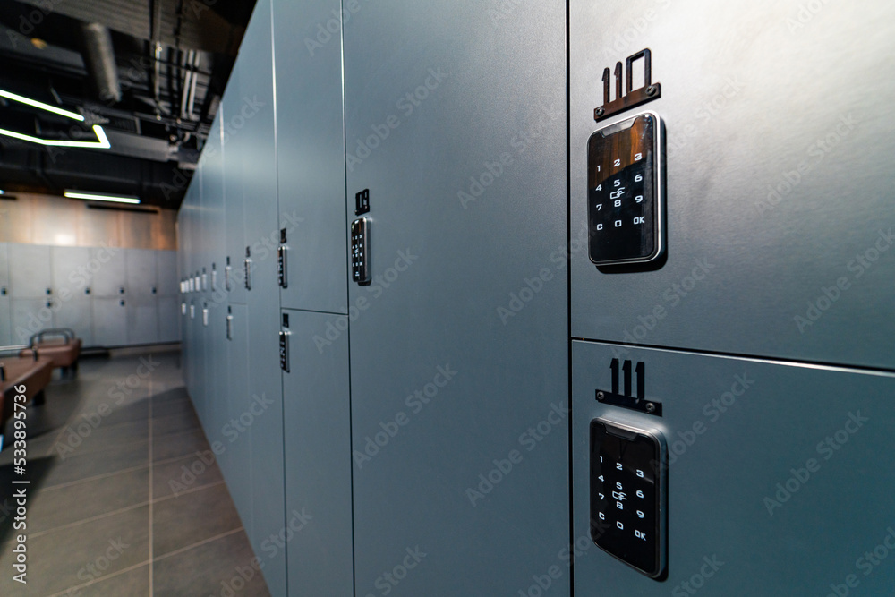 Luxury dark closet lockers. Modern fitness club locker room.