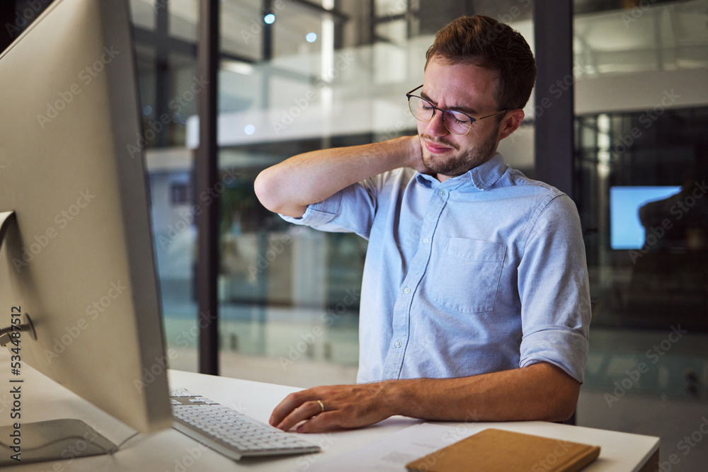 Burnout, neck pain and tired with an exhausted businessman working on a computer in his office late 