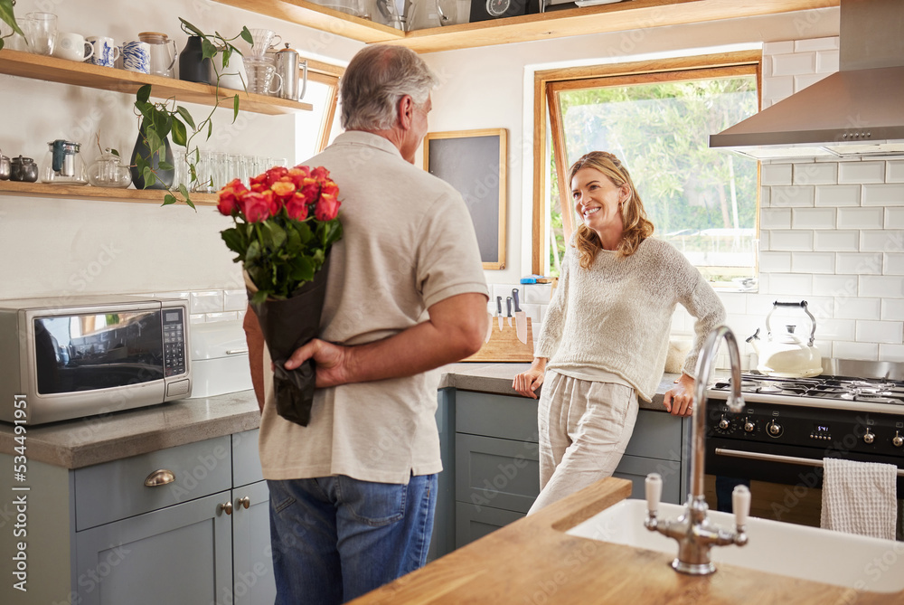 Senior, couple and flowers for love in kitchen, husband with bouquet of roses to wow wife, happy and