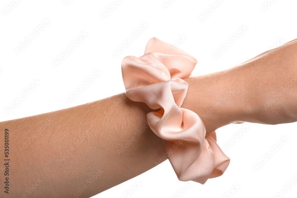 Closeup view of female hand with silk scrunchy on white background