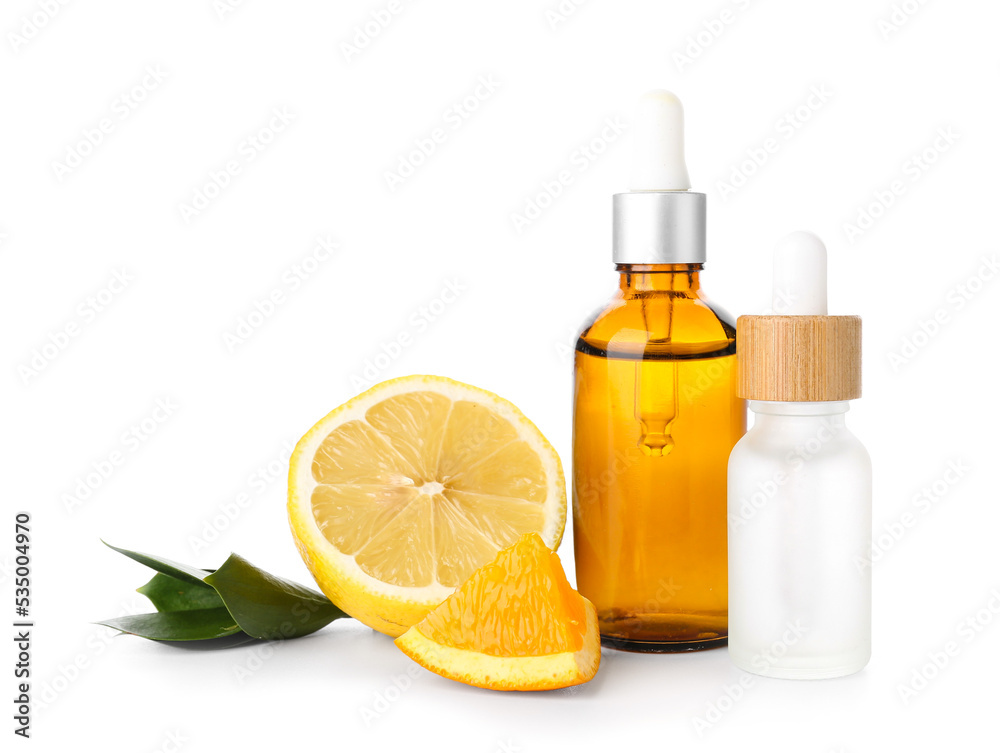 Bottles of citrus serum on white background