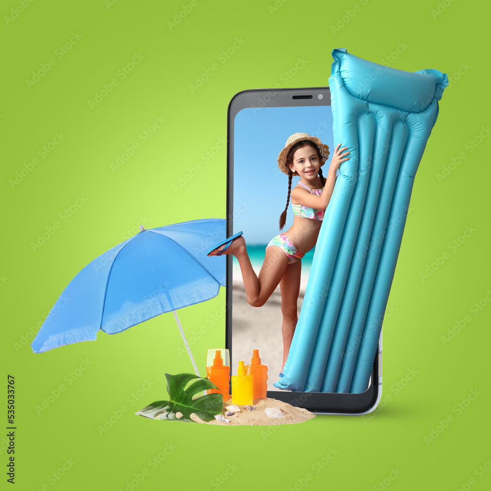 Cute little girl with inflatable mattress, umbrella, sunscreen cream and mobile phone on green backg