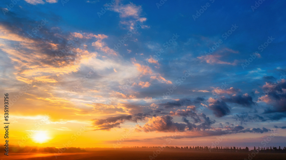 The dawn sky over the village. A wonderful morning landscape