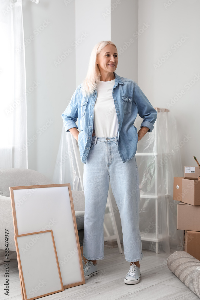 Mature woman in living room on moving day