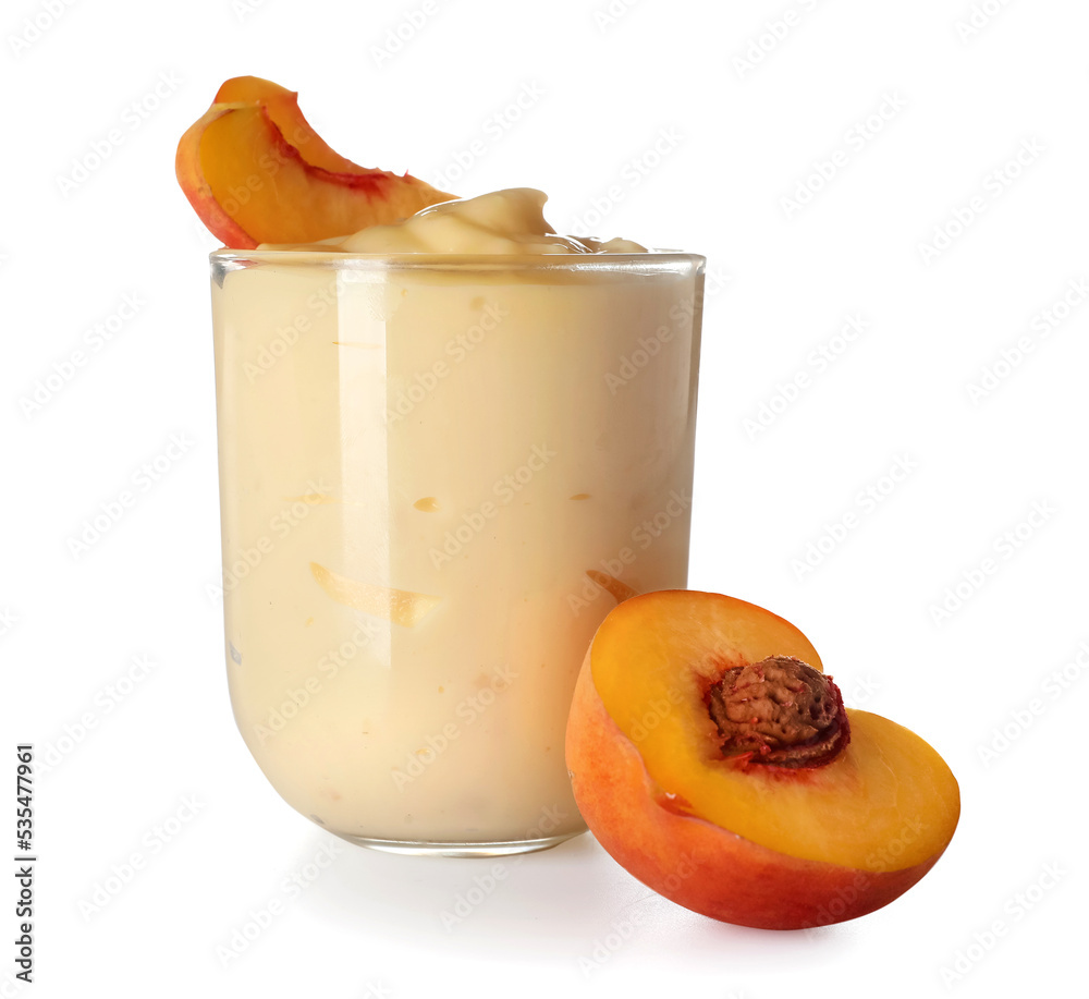 Glass of tasty vanilla pudding and peach on white background