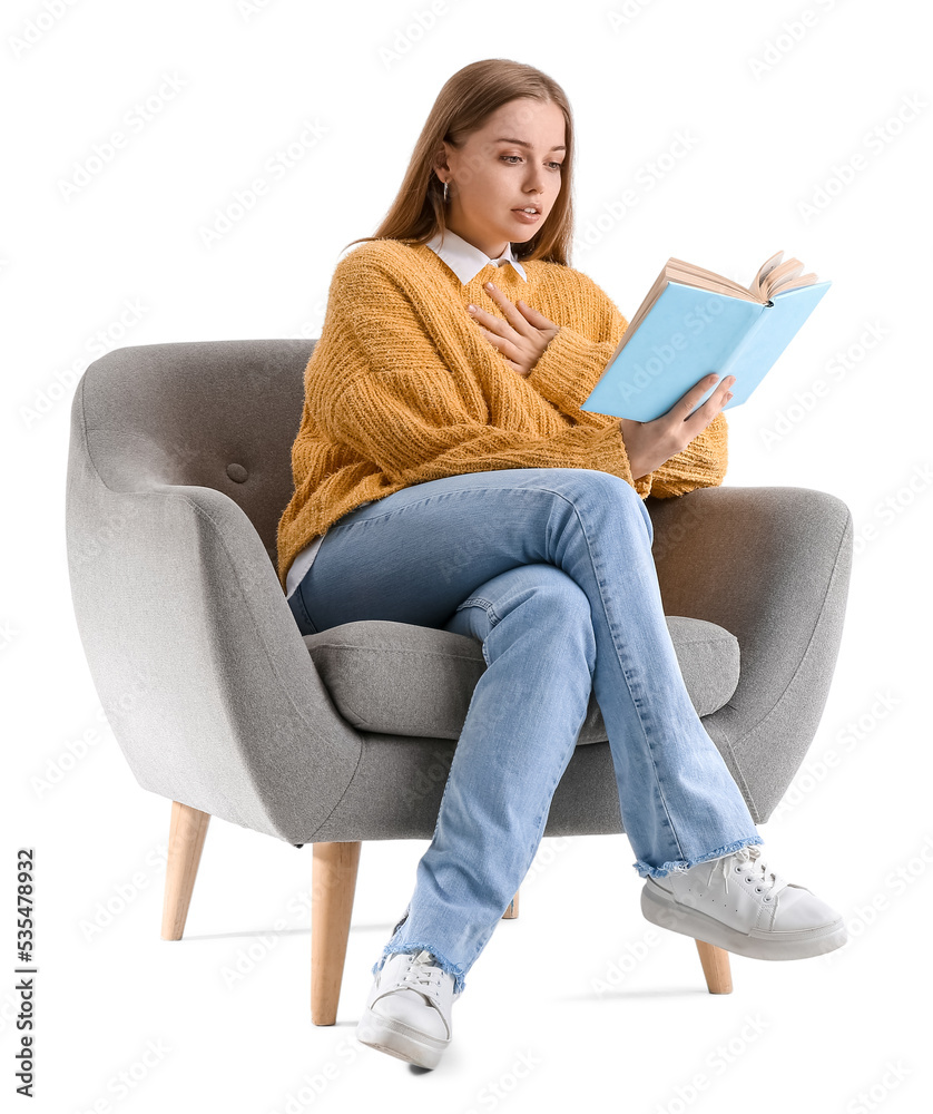 Young woman reading book in armchair on white background