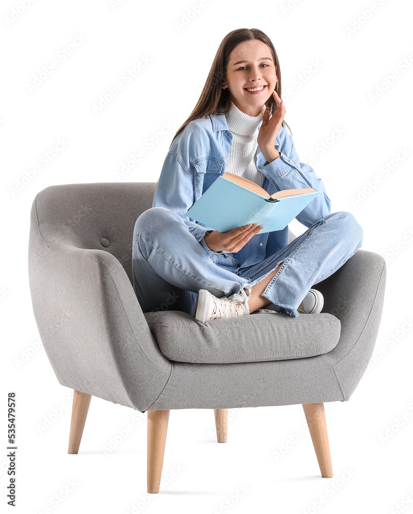 Beautiful woman with book sitting in soft armchair on white background