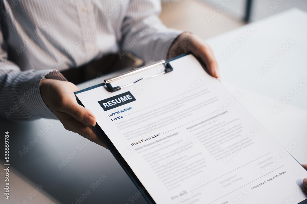 Businesswoman Holding Resume,Examiner reading a resume during job interview at office Business and h