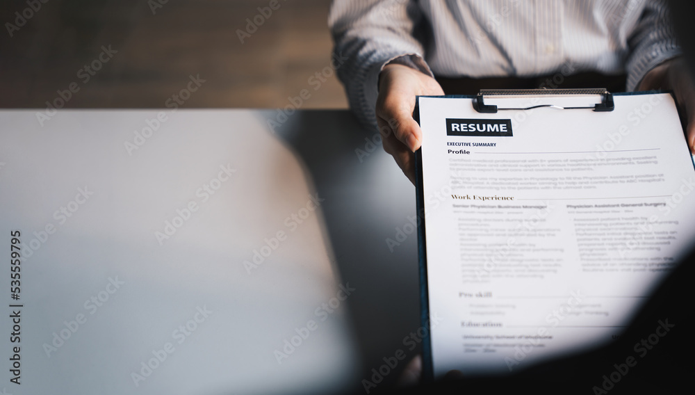 Businesswoman Holding Resume,Examiner reading a resume during job interview at office Business and h