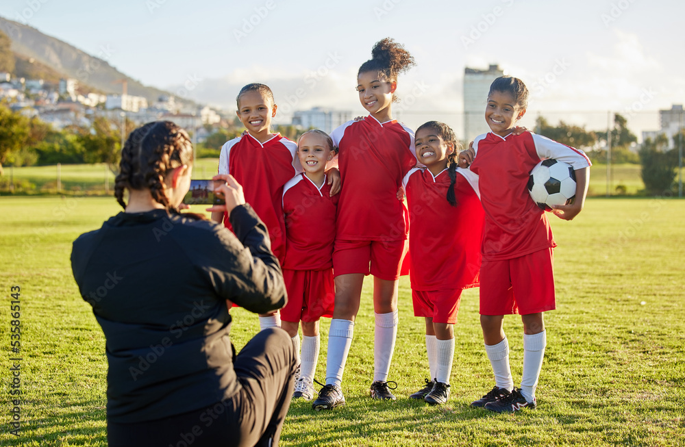 Soccer, photograph and sports coach with a girl team posing for a picture outdoor on a football fiel