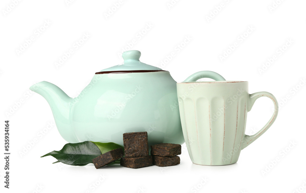 Dry pressed puer tea with leaves, cup and teapot on white background