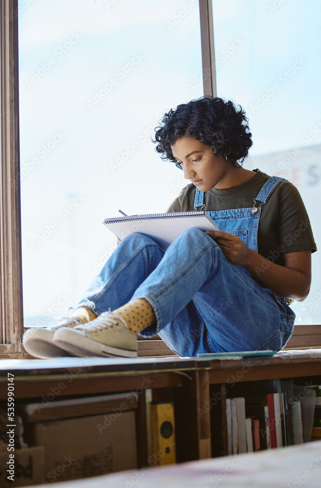 Creative, art and woman drawing by a window and sitting in her artistic studio or workshop. Creativi