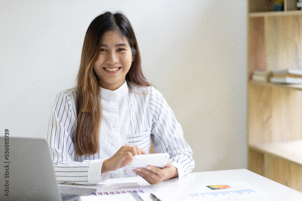 Businesswoman in the office working on business financial reports analyzing company financial statis