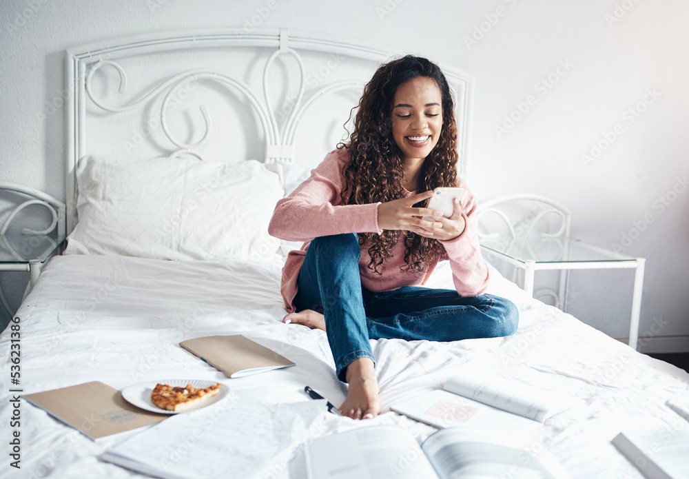 Books, bed and woman with a phone reading social media and internet posts on break from studying in 