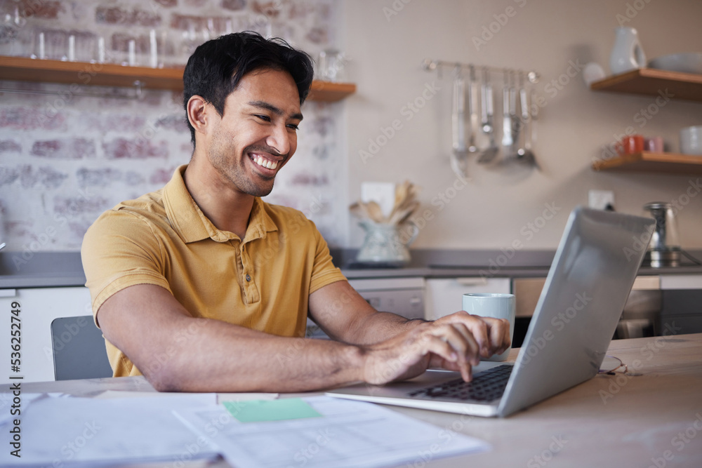 Man, working on report from home or use laptop for internet search at his kitchen table. Asian with 