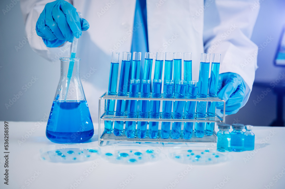 Scientist mixing chemical liquids in the chemistry lab. Researcher working in the chemical laborator