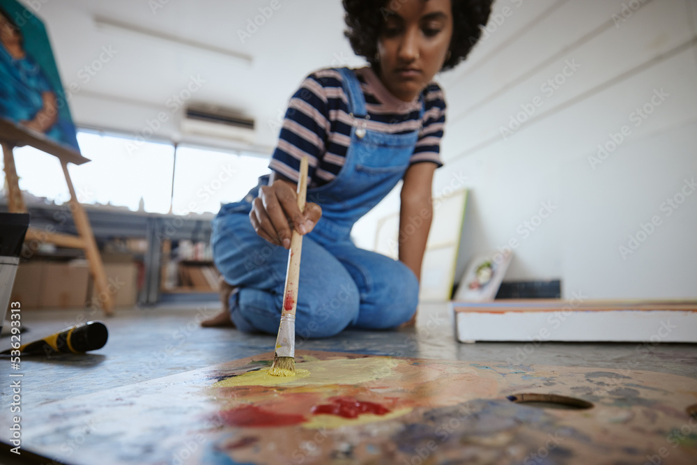 Woman artist, painting and canvas on floor in art studio for creative exhibition, design academy and