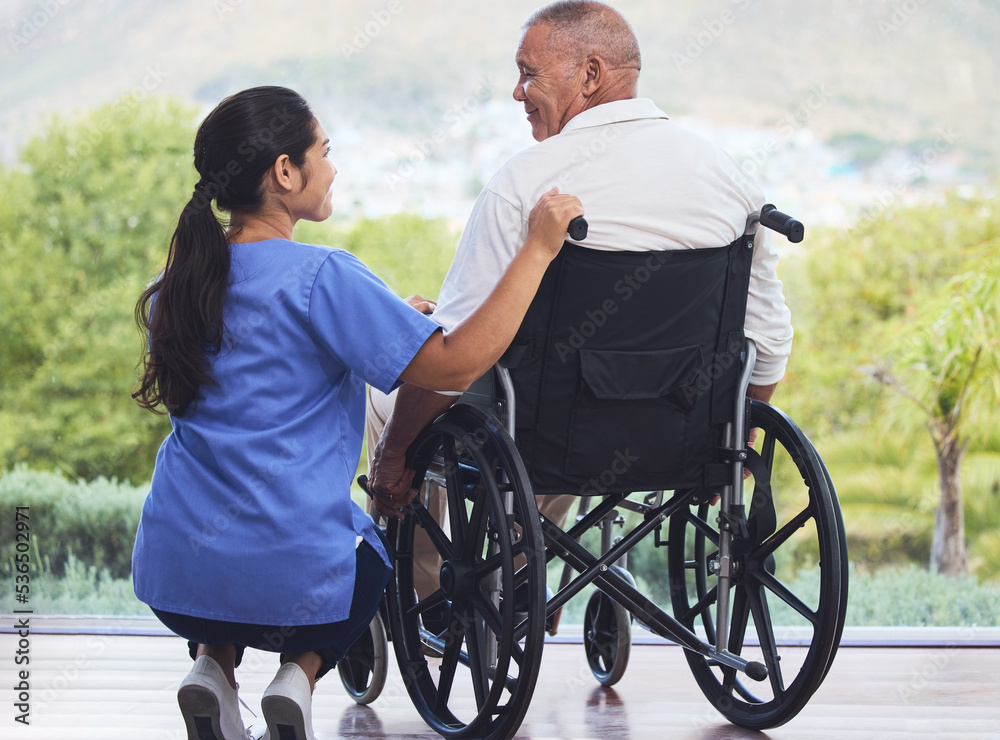 Healthcare, disability and man in wheelchair with nurse on retirement or nursing home patio. Senior 