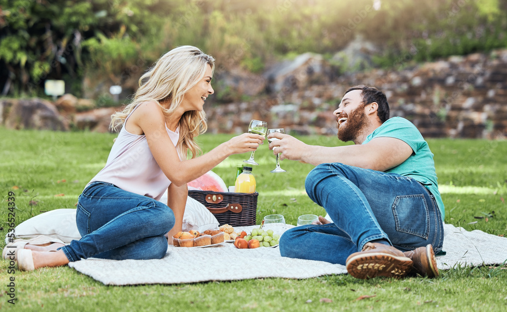 Couple, picnic and park of a man and woman cheers to happiness and love in nature. Happy people toge