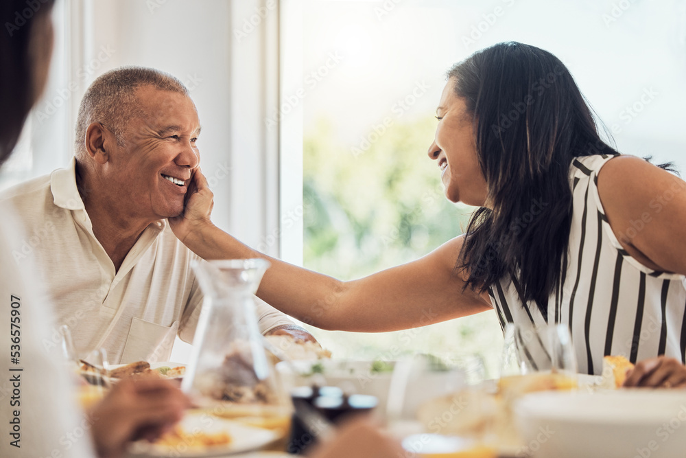 Couple, love and food with a woman and man eating during a family lunch or dinner in their home toge