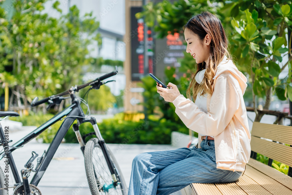 Beautiful Asian woman listening favourite music on headphones from mobile phone, Happiness relaxatio