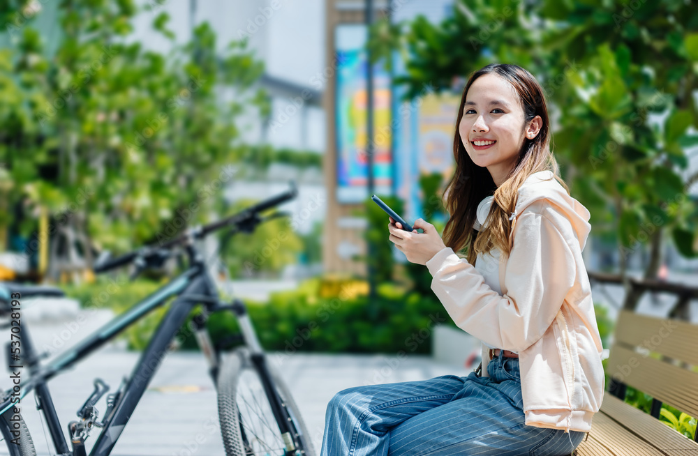 Beautiful Asian woman listening favourite music on headphones from mobile phone, Happiness relaxatio