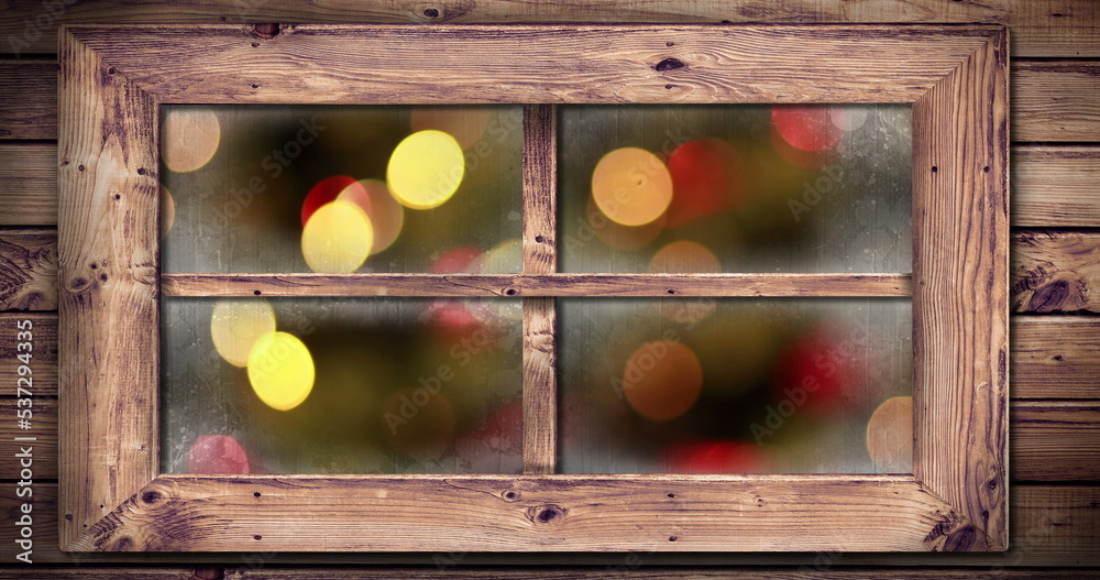 Image of window with blurred christmas tree and decorations