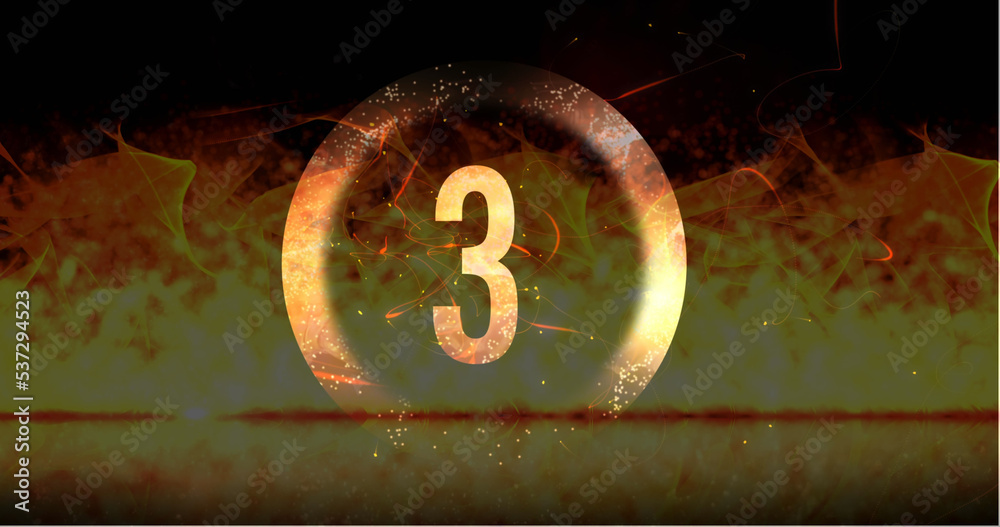 Image of ring and glowing number three in dramatic countdown over flaming fire background