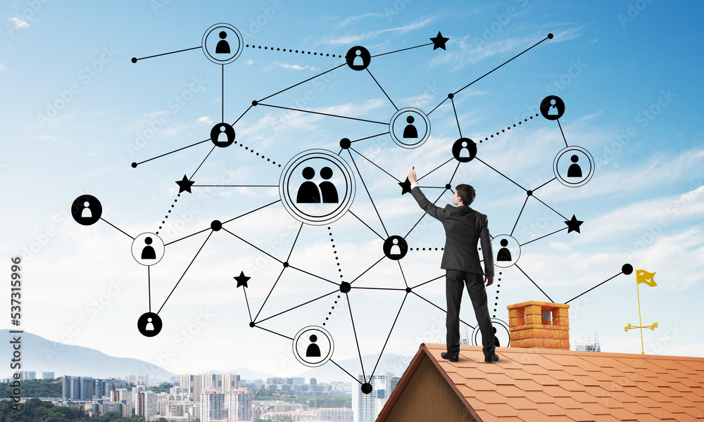 Businessman on house roof presenting networking and connection concept. Mixed media