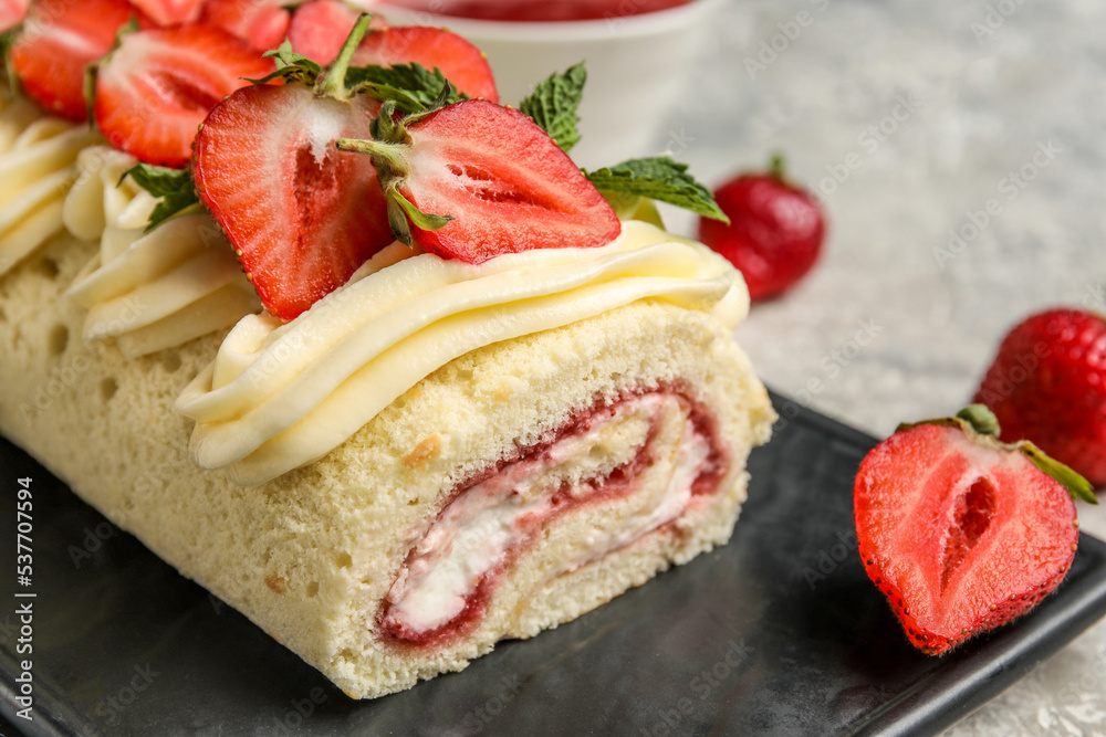 Board with delicious strawberry roll cake, closeup